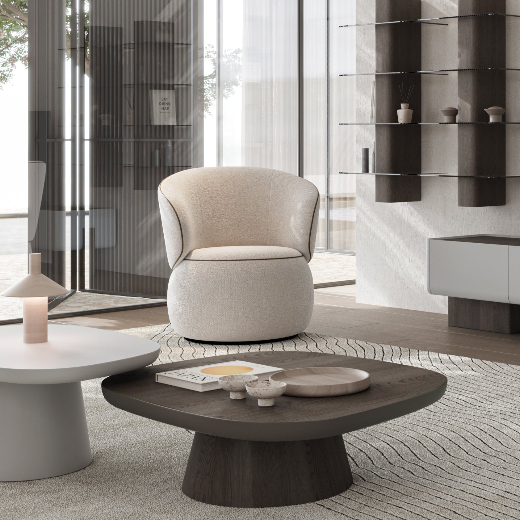 Moss Swivel Armchair in cream upholstery with black piping and rounded base