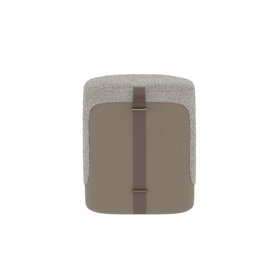 Small ottoman with textured beige top and brown strap on a white background
