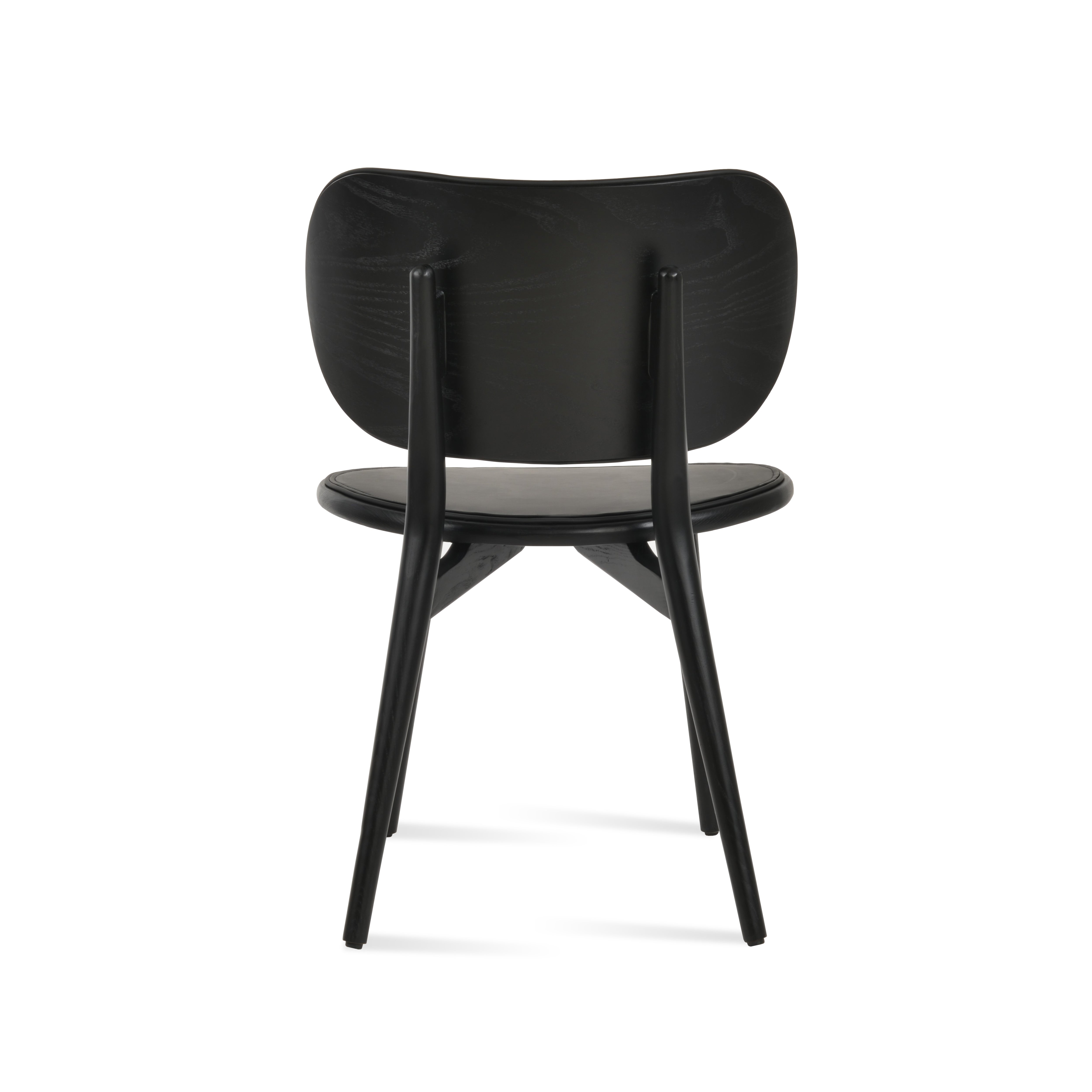 Aaron Dining Chair from the back, showcasing its sleek design and durable black construction.