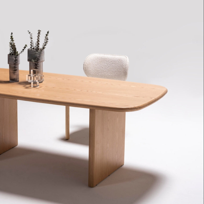 Alva Dining Table styled in a contemporary dining room with minimalist decor and pendant lighting.