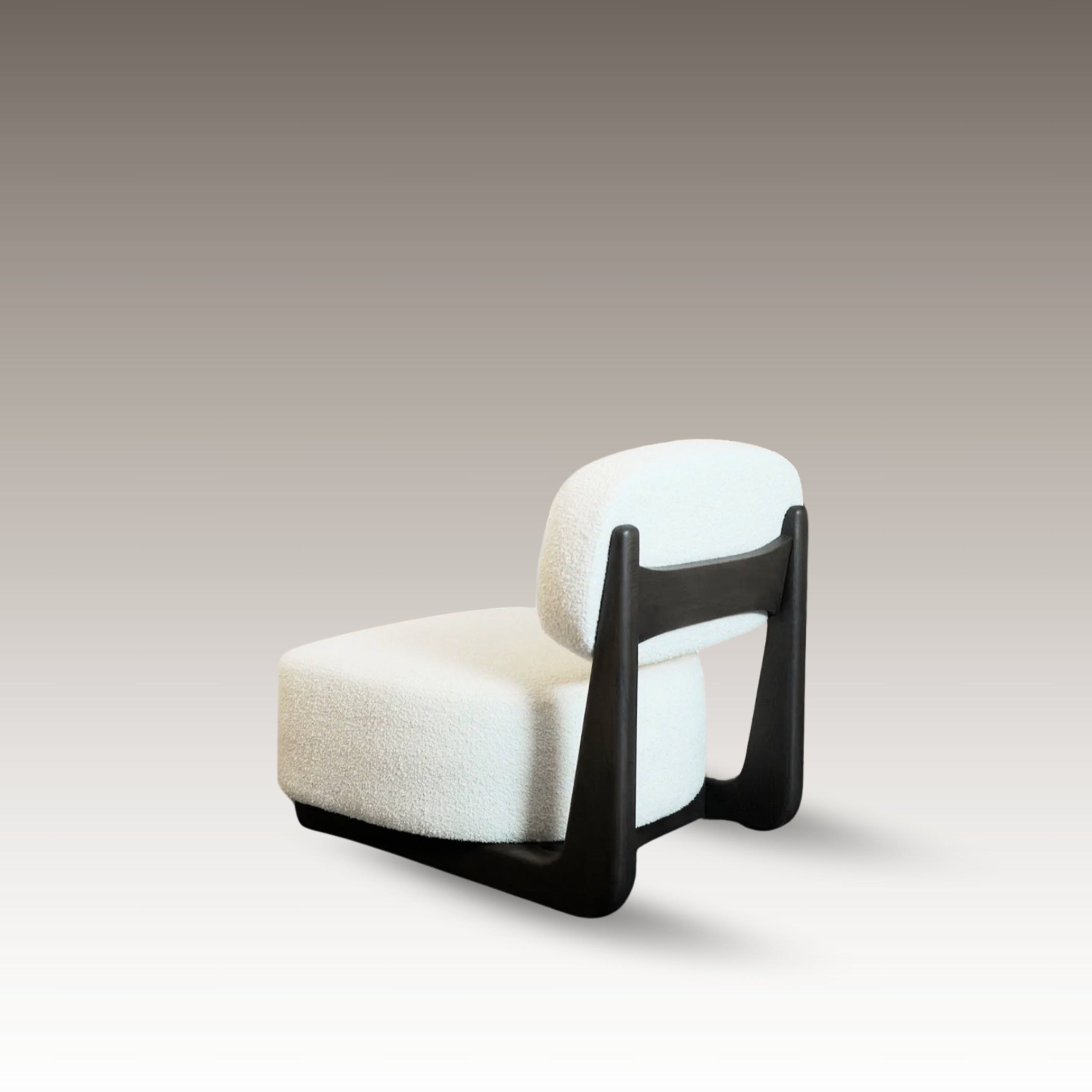 Aura armchair with curved backrest and dark wooden frame in studio setting