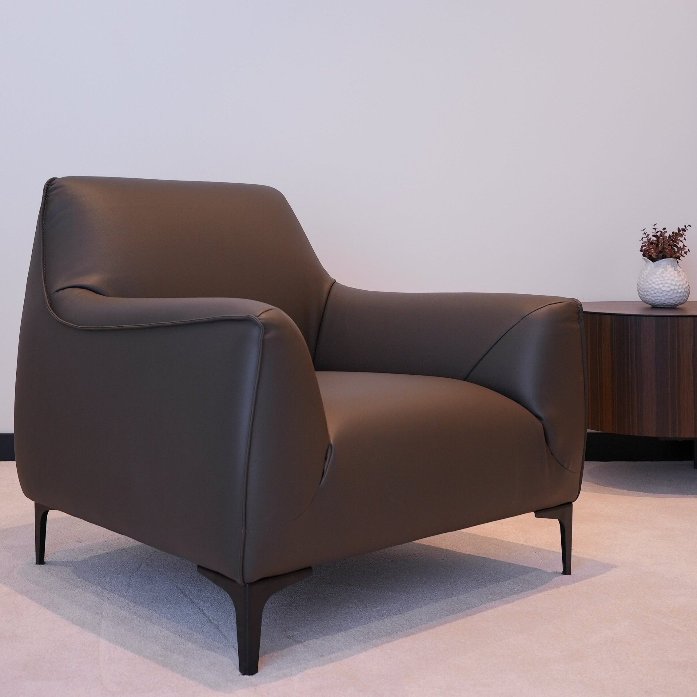 Angled view of Belluna Armchair in a modern interior with soft lighting