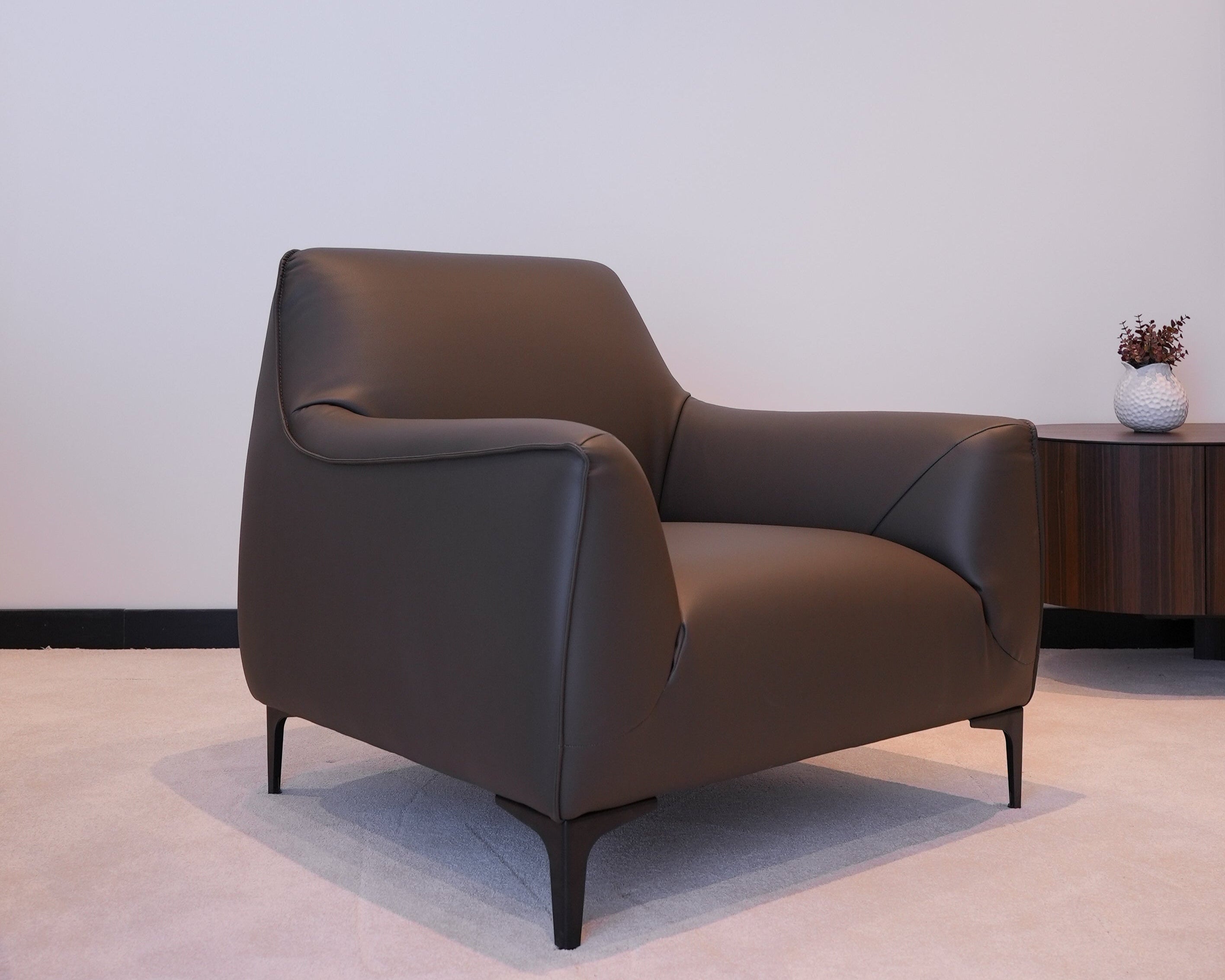 Angled view of Belluna Armchair in a modern interior with soft lighting