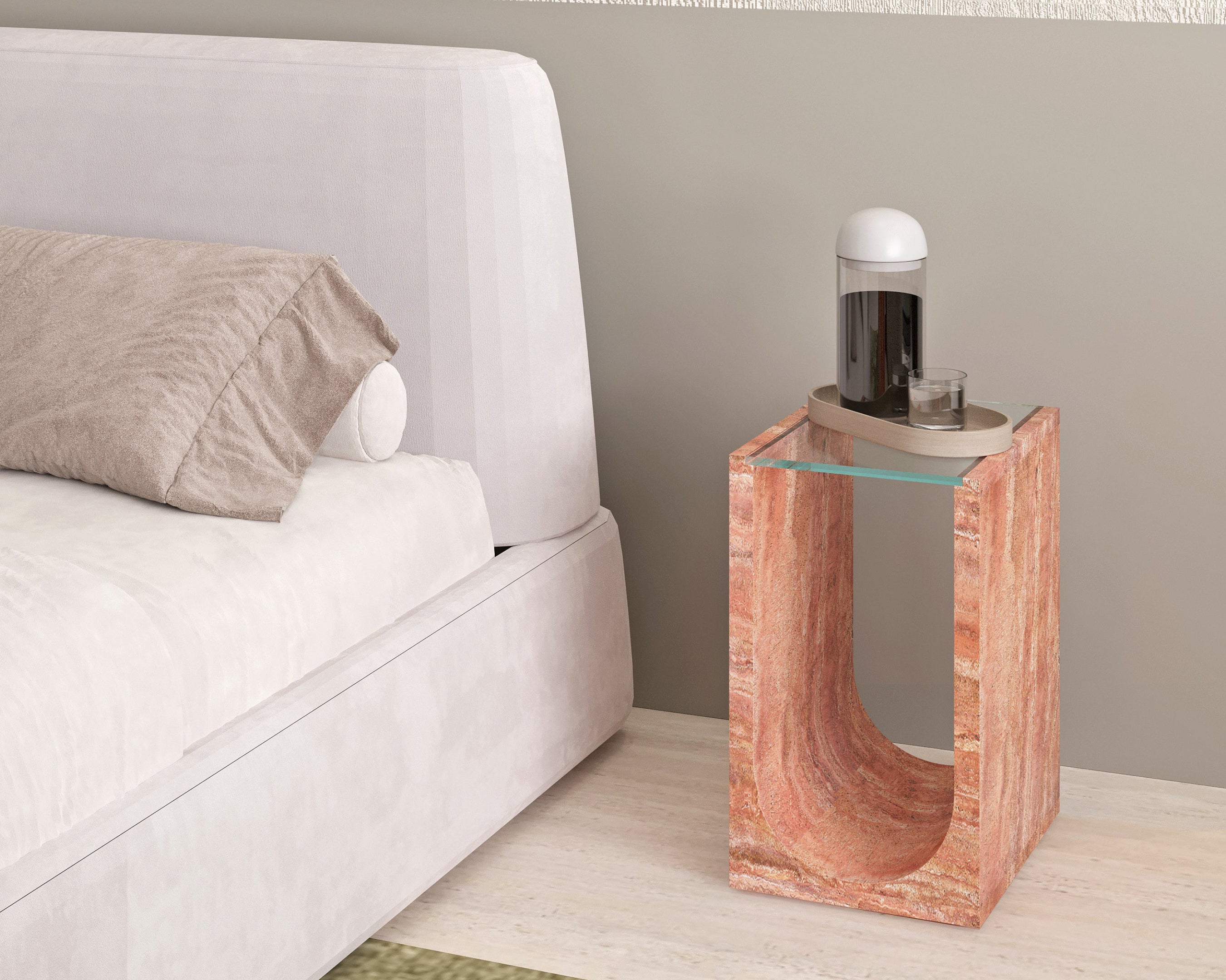  a travertine side table next to a bed