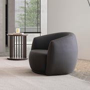 Classico Leatherette Armchair styled in a modern living room with minimalist decor and a floor lamp.