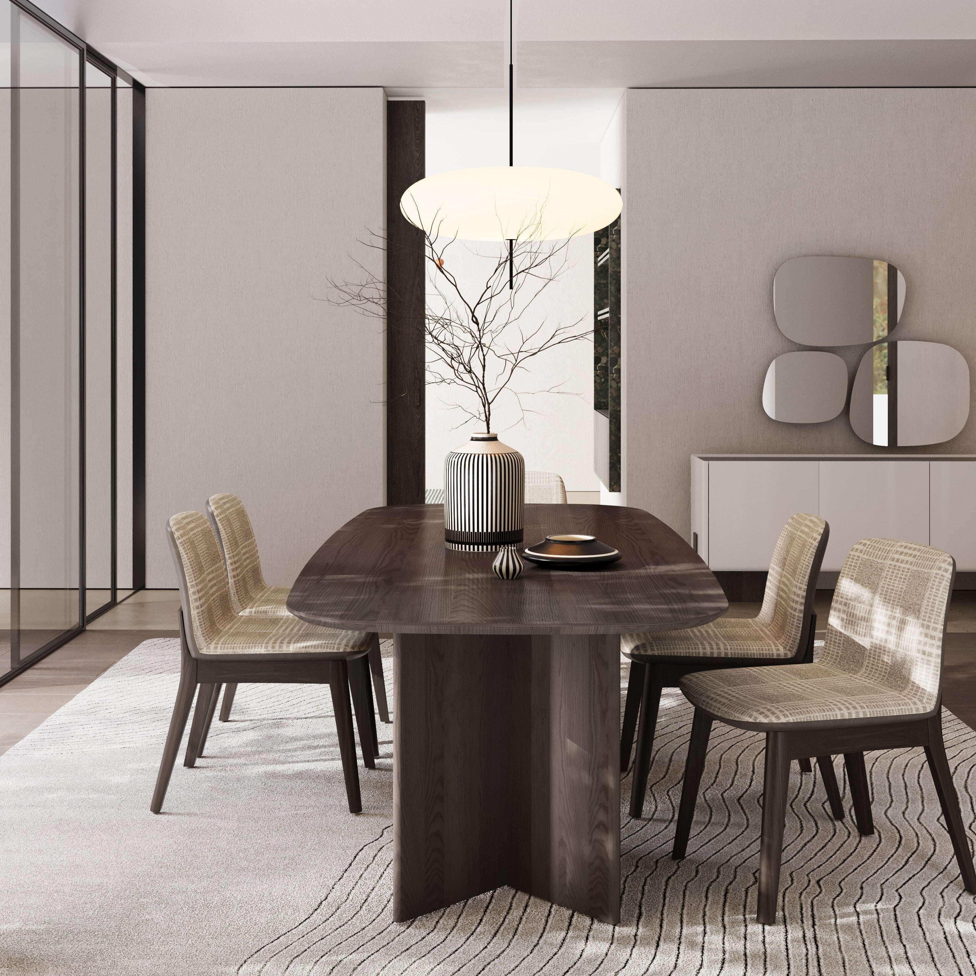 Modern dining room with wooden table and chairs, light fixture, and decorative elements.