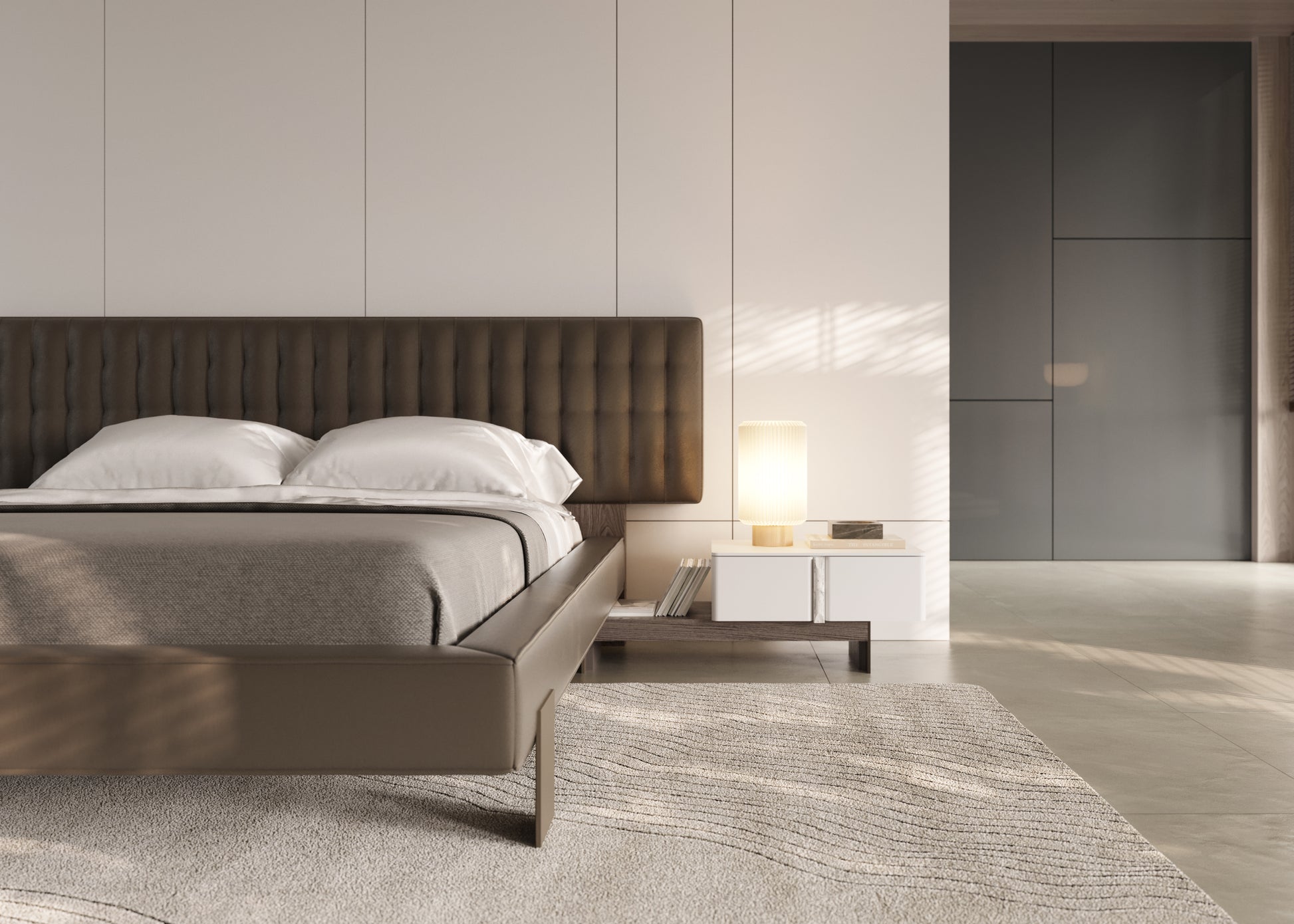 Modern bedroom with a bed, nightstand, and lamp in a minimalistic setting.