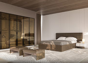 Modern bedroom with a bed, nightstands, and a large mirror.