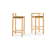 Two wooden bar stools with cushioned seats on a white background