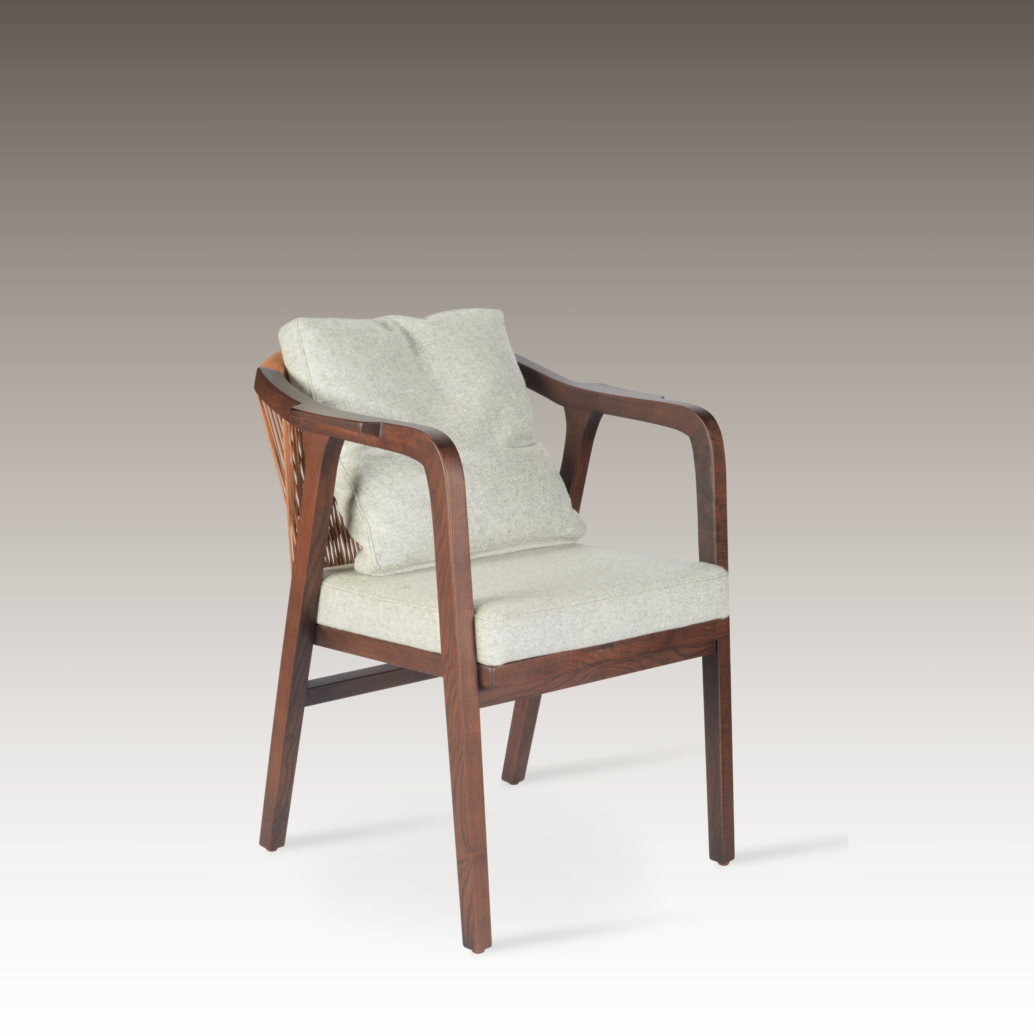 Breeze Dining Chair with soft cushions and wooden frame against a gradient background.