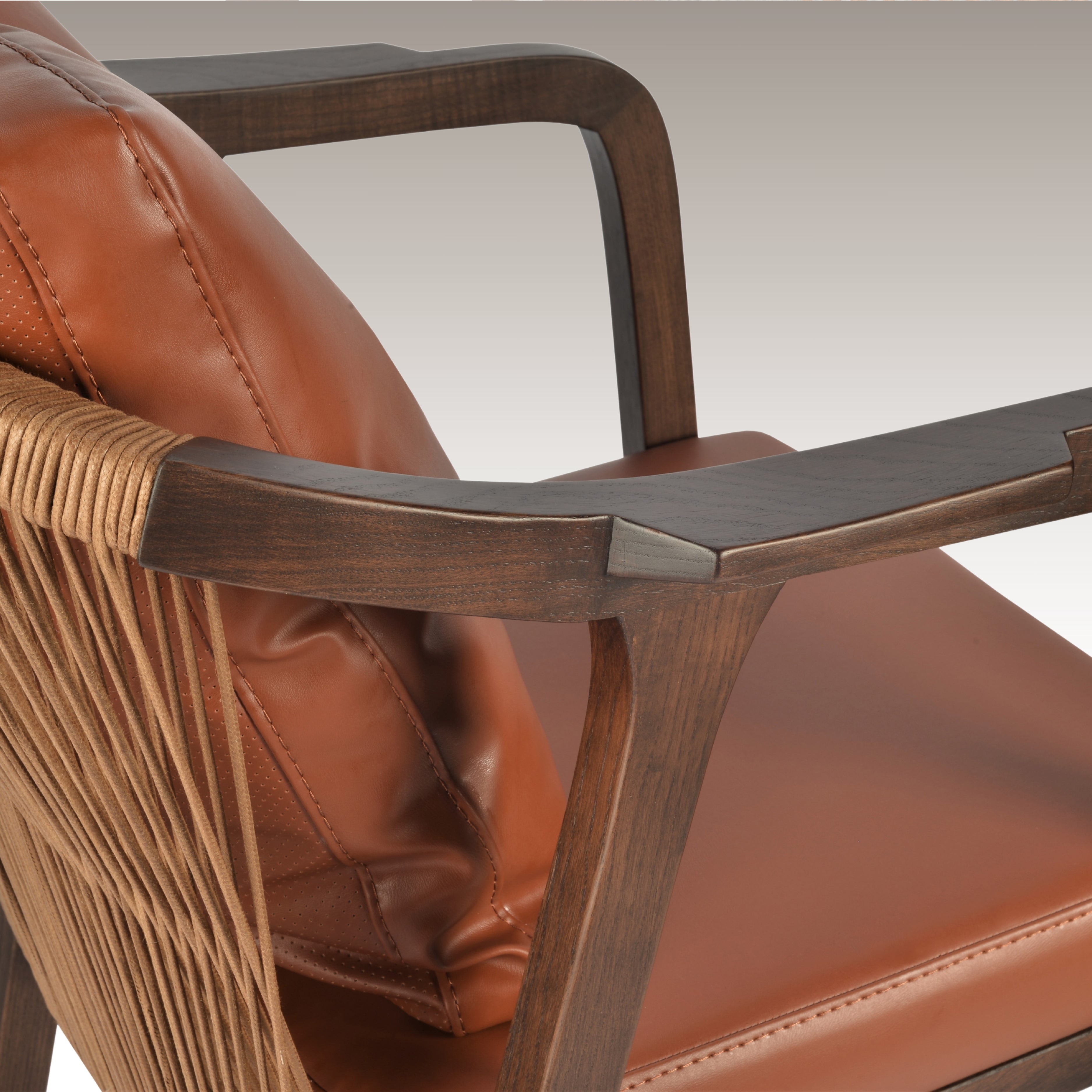 Close-up of the Breeze Dining Chair showcasing its wooden armrests and leather cushion.