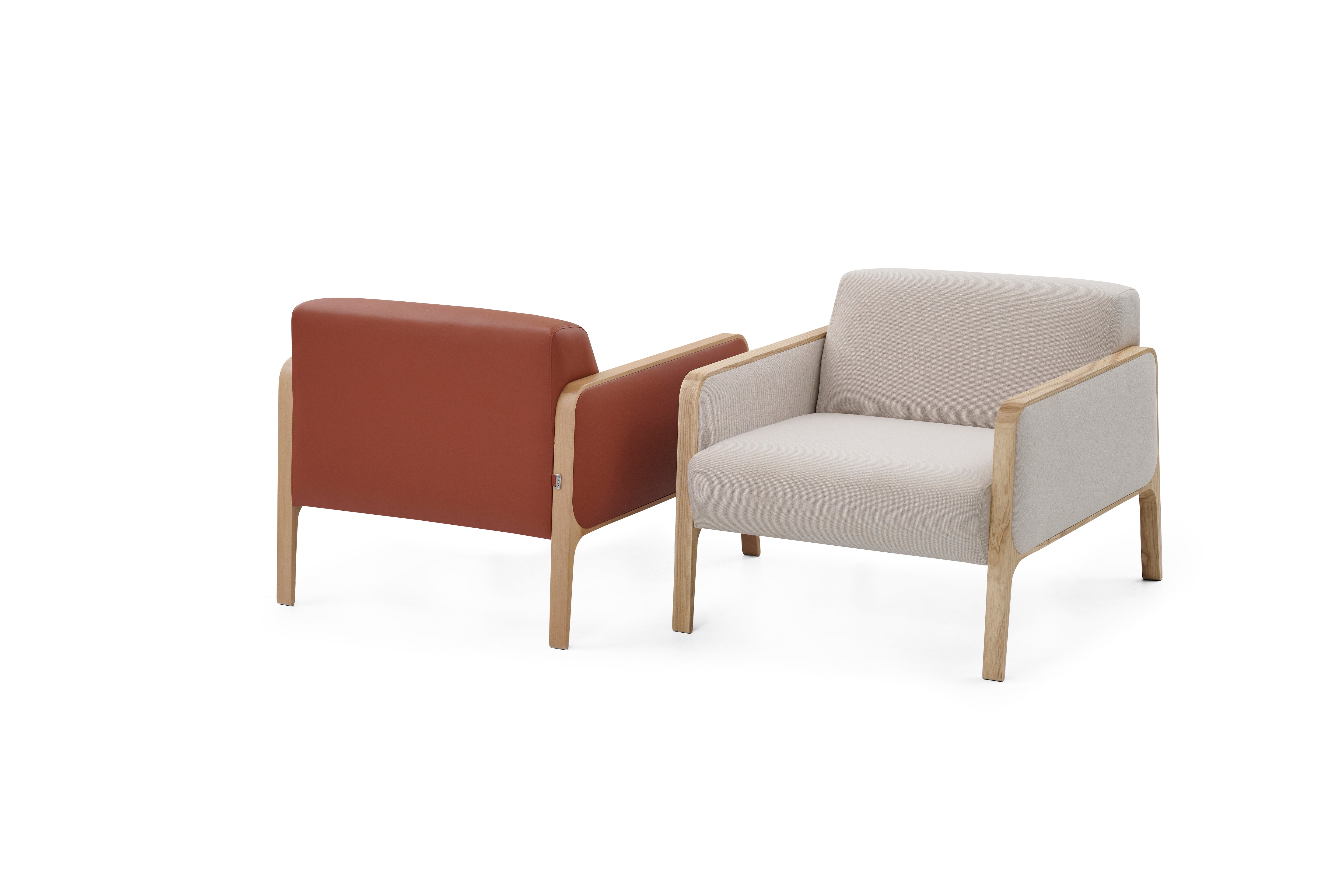 Two armchairs, one with brown leather and the other with beige fabric, on a white background.