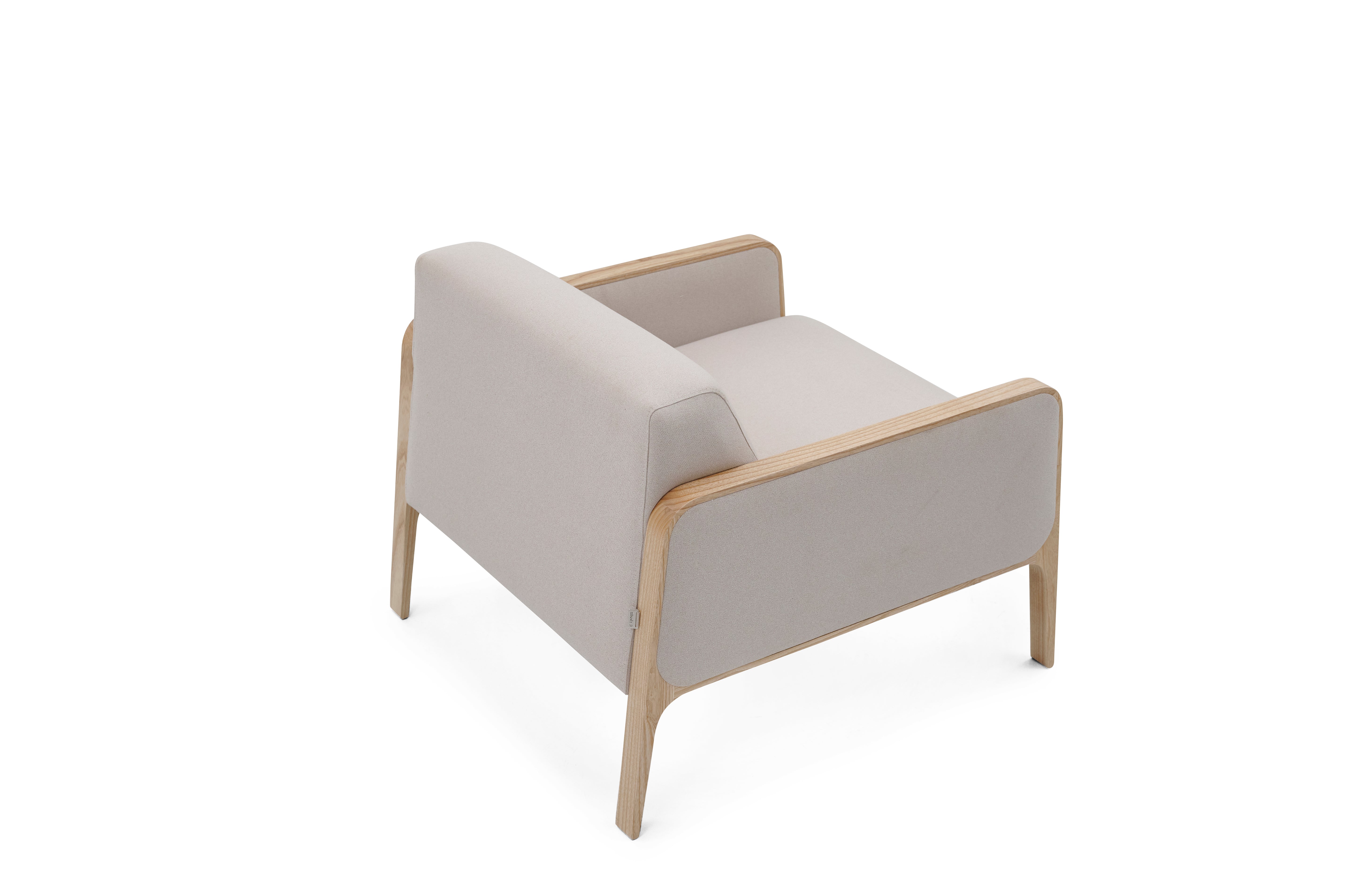 Modern armchair with beige cushion on a white background