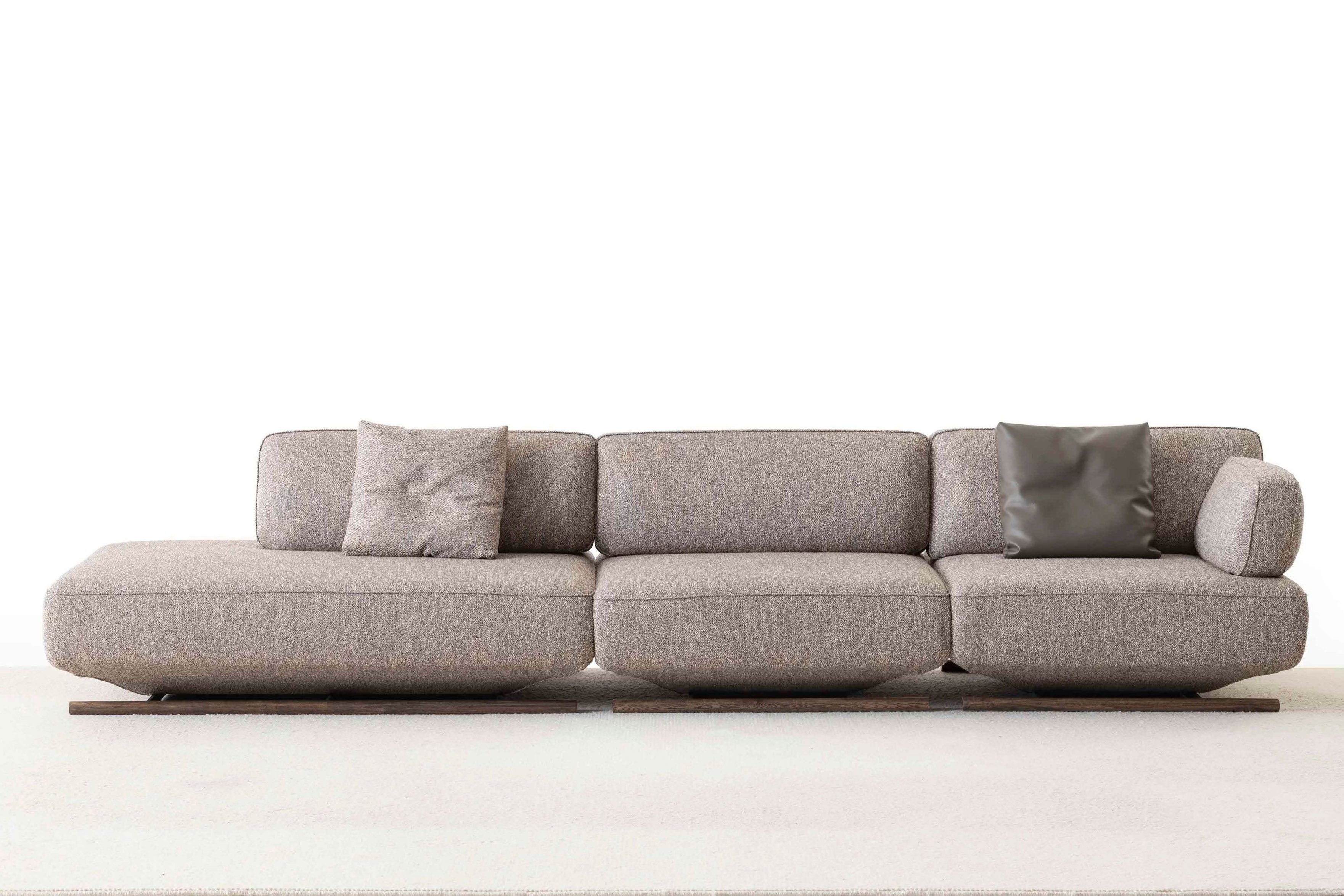 Gray sectional sofa with cushions on a white background