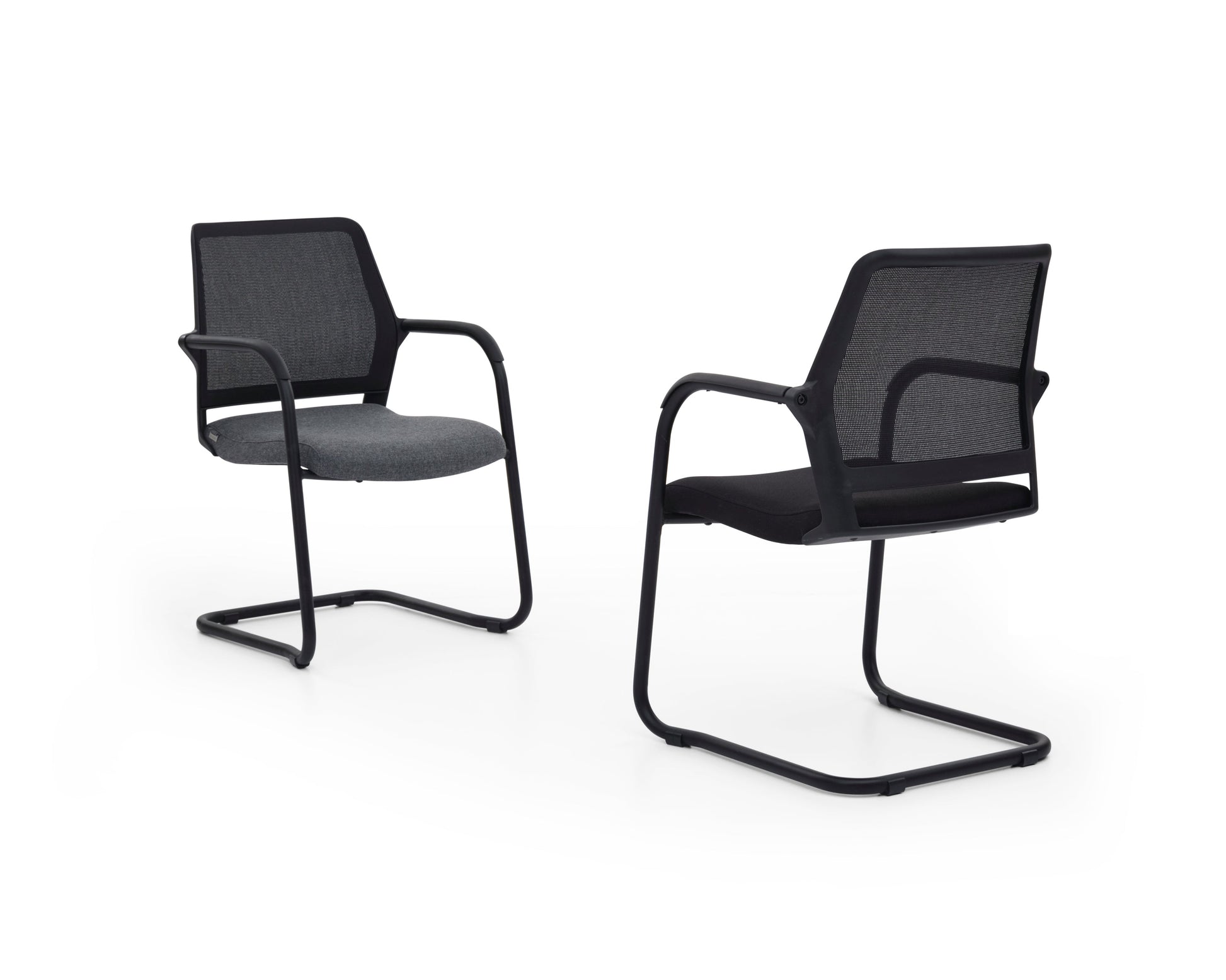 Two black office chairs with mesh backrests on a white background
