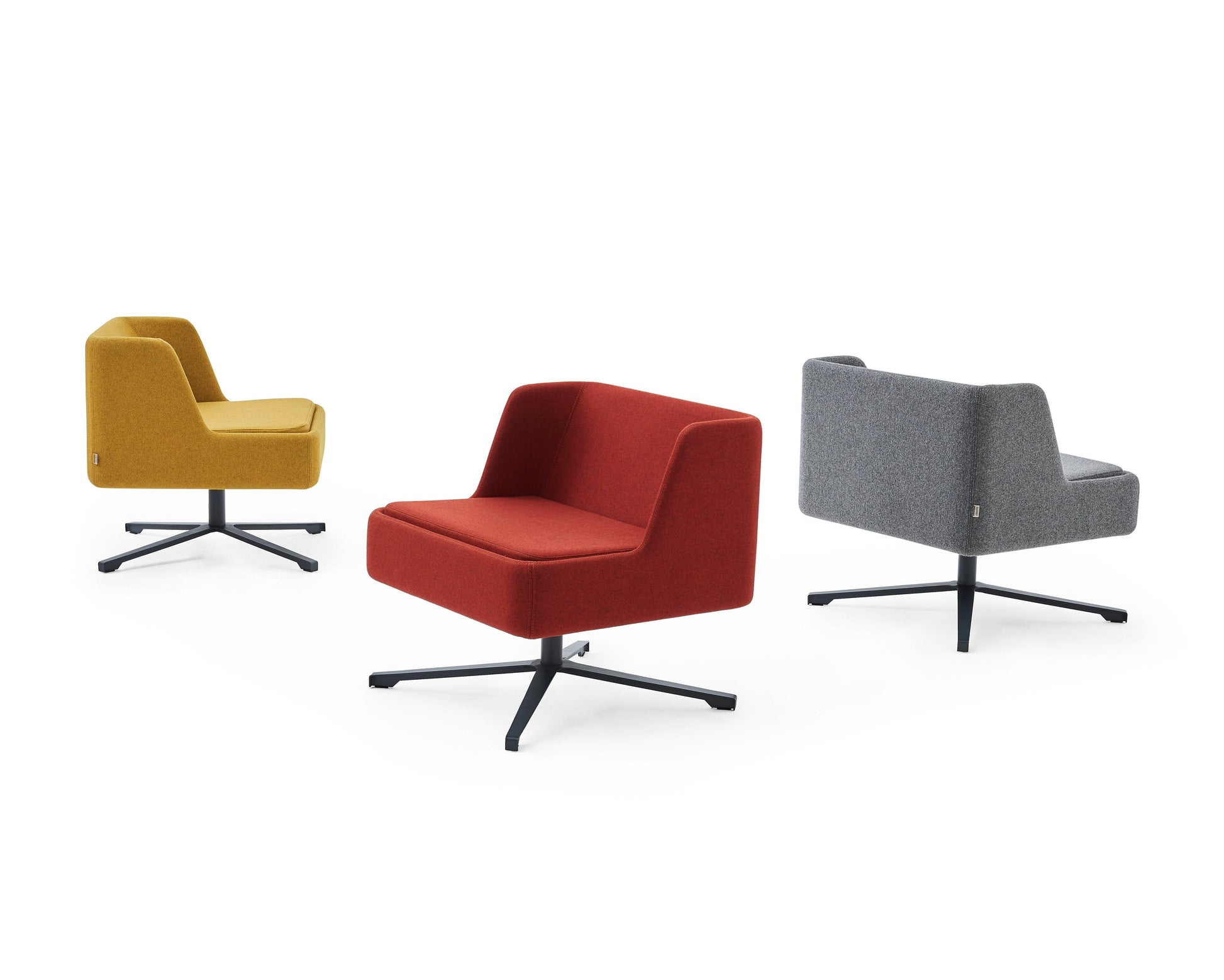 Three modern armchairs in yellow, red, and gray on a white background