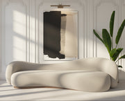 Orelle Sofa in beige inside a stylish room with abstract art and a plant