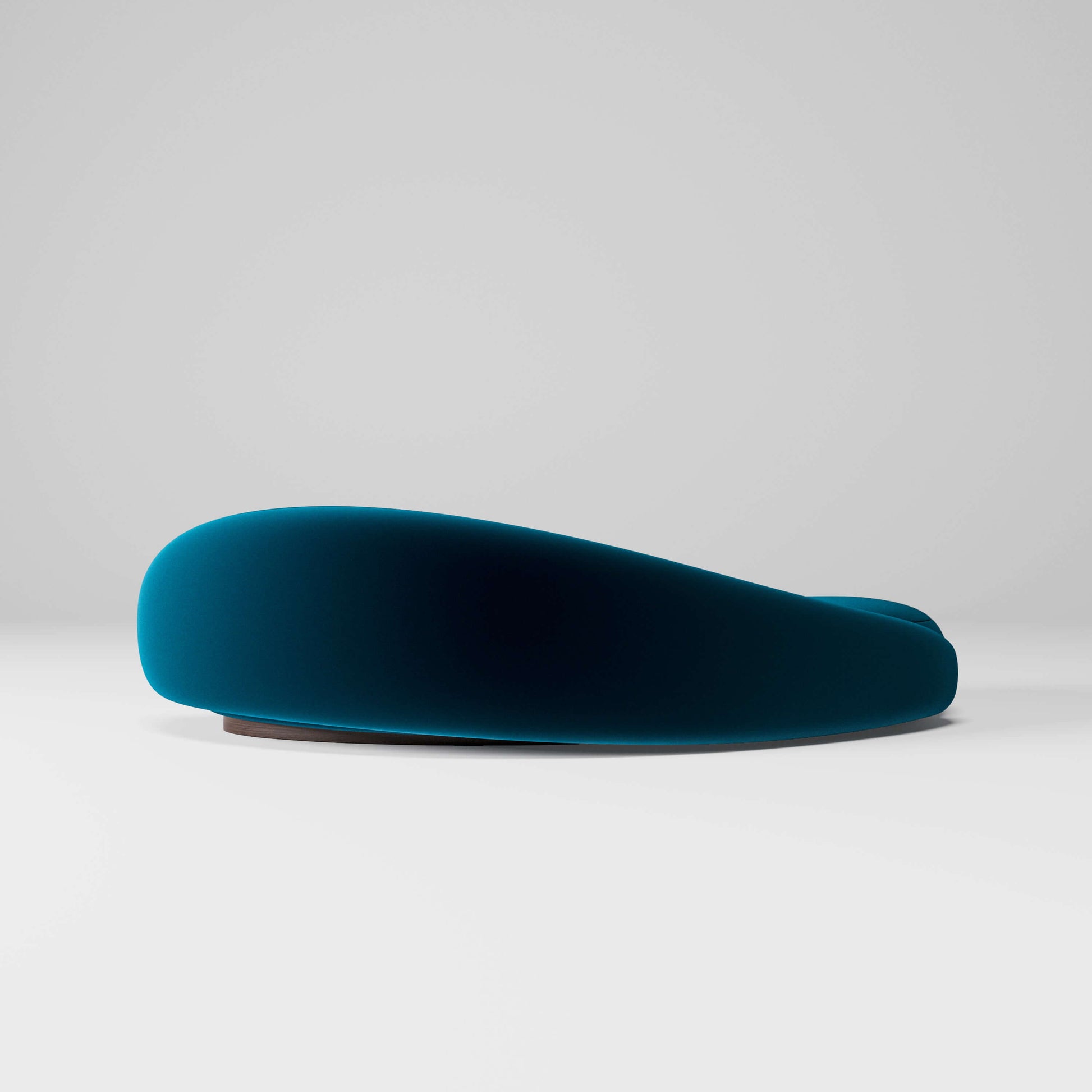 Papilio Curved Sofa in elegant ocean blue, showcasing a modern sculptural design with gentle curves.