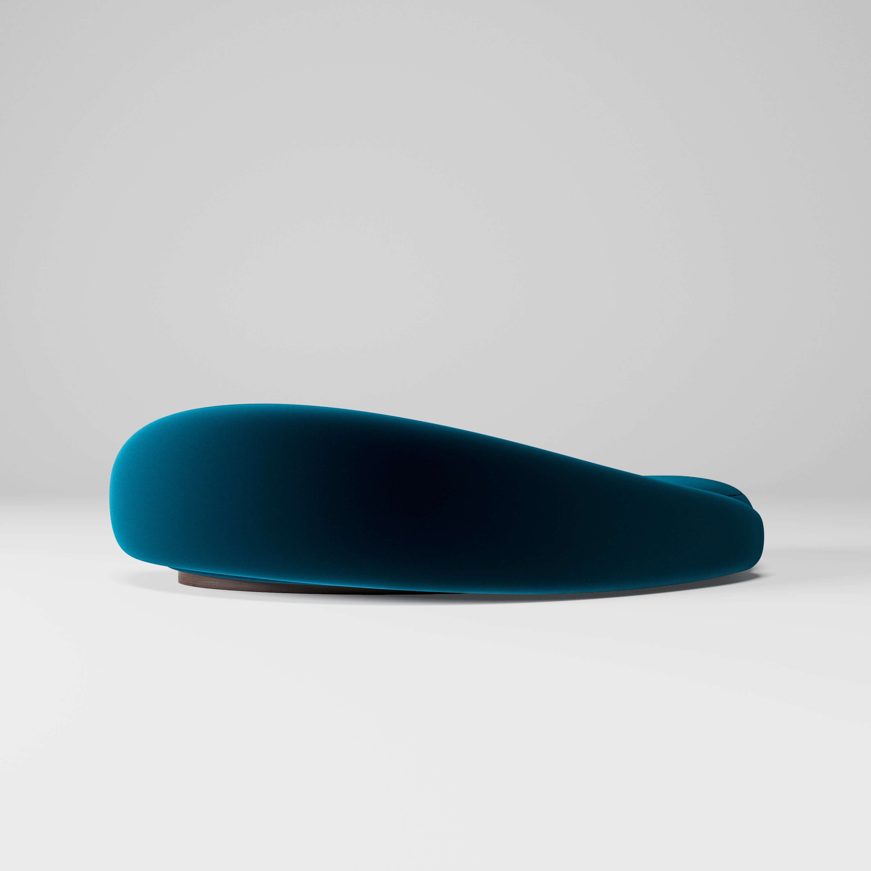 Papilio Curved Sofa in elegant ocean blue, showcasing a modern sculptural design with gentle curves.