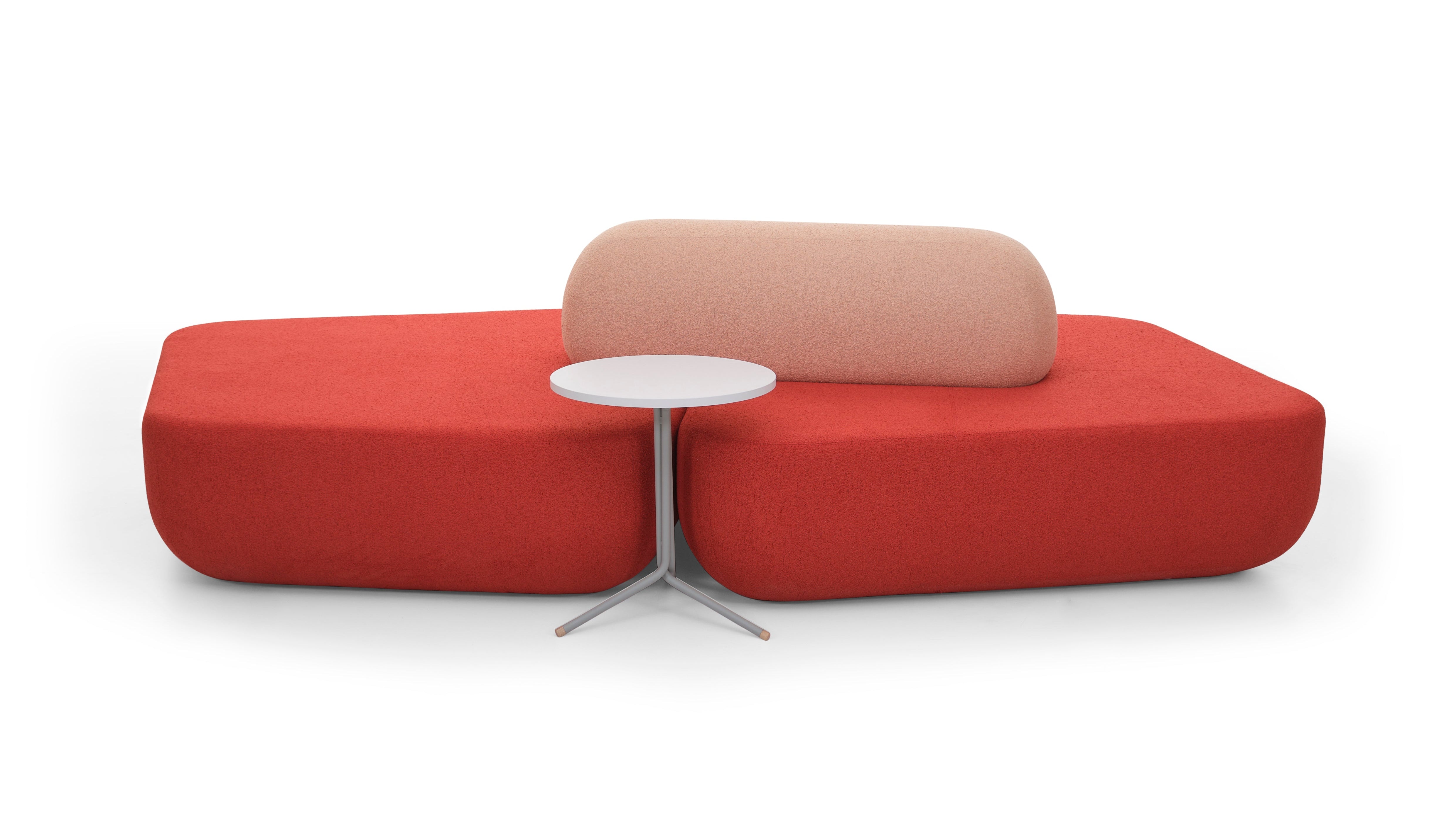 Modern red and beige sofa with a small round table on a white background