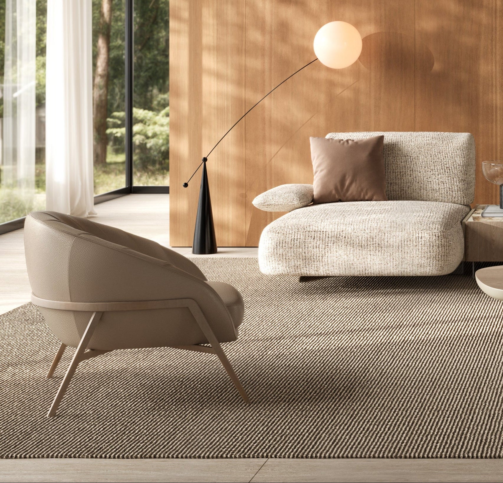 Modern living room with beige sofa, armchair, and coffee table in a well-lit room with wooden walls.