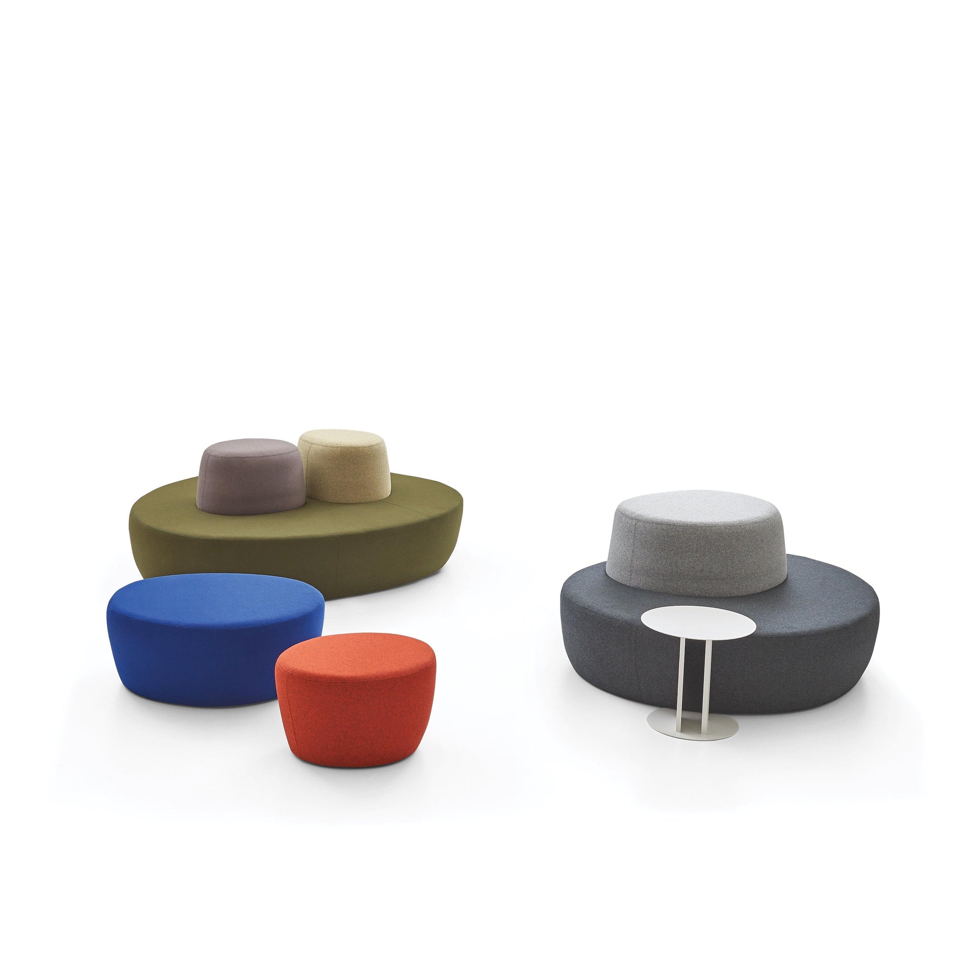 Set of colorful round  poufs and a small round table on a white background