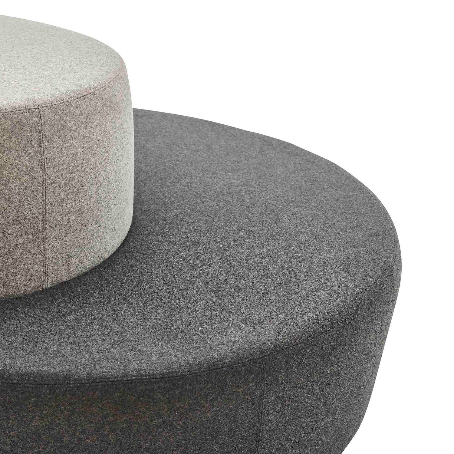 Two gray textured cylindrical objects stacked on a white background