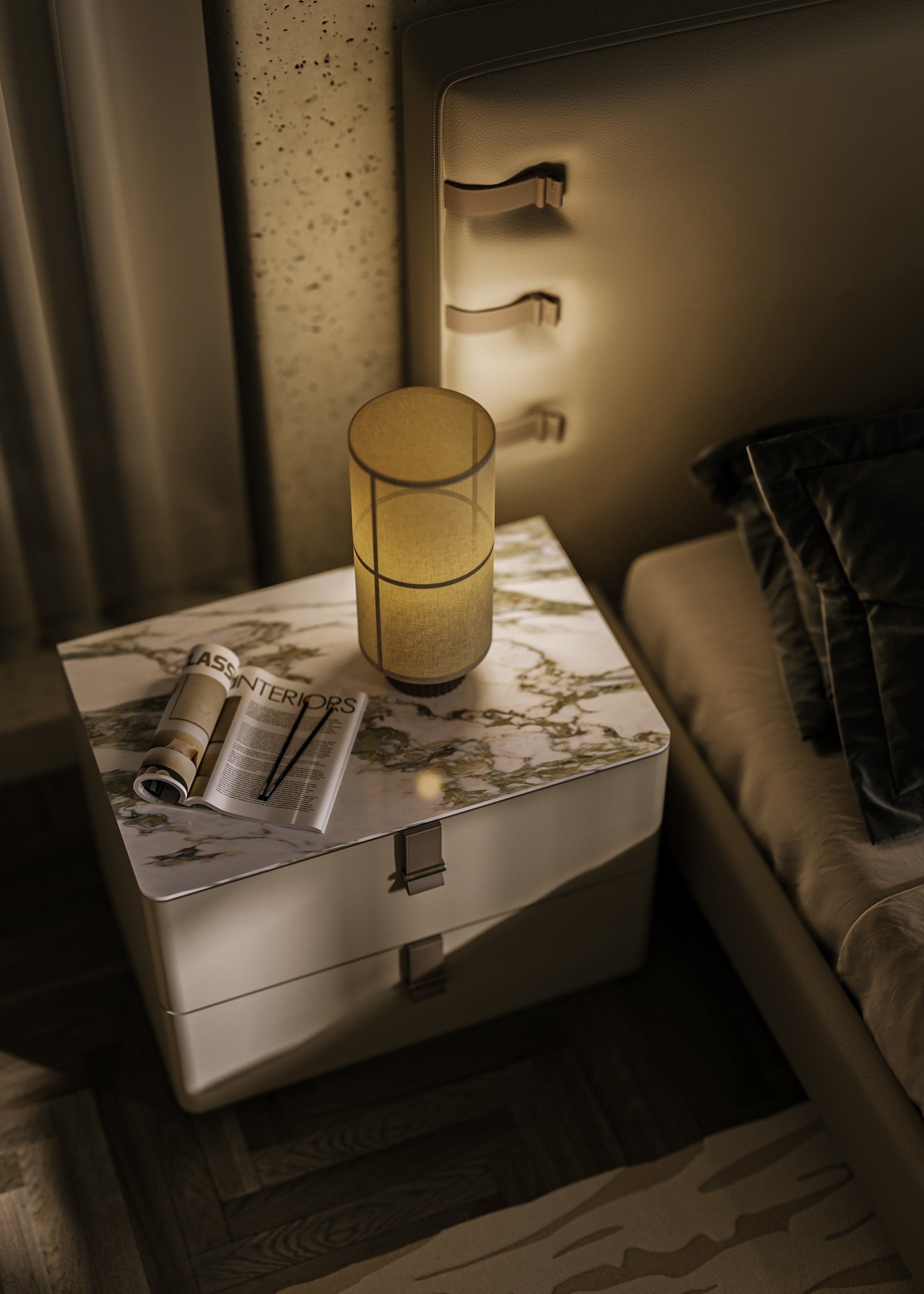 Nightstand with lamp, newspaper, and folded blanket in a dimly lit room.
