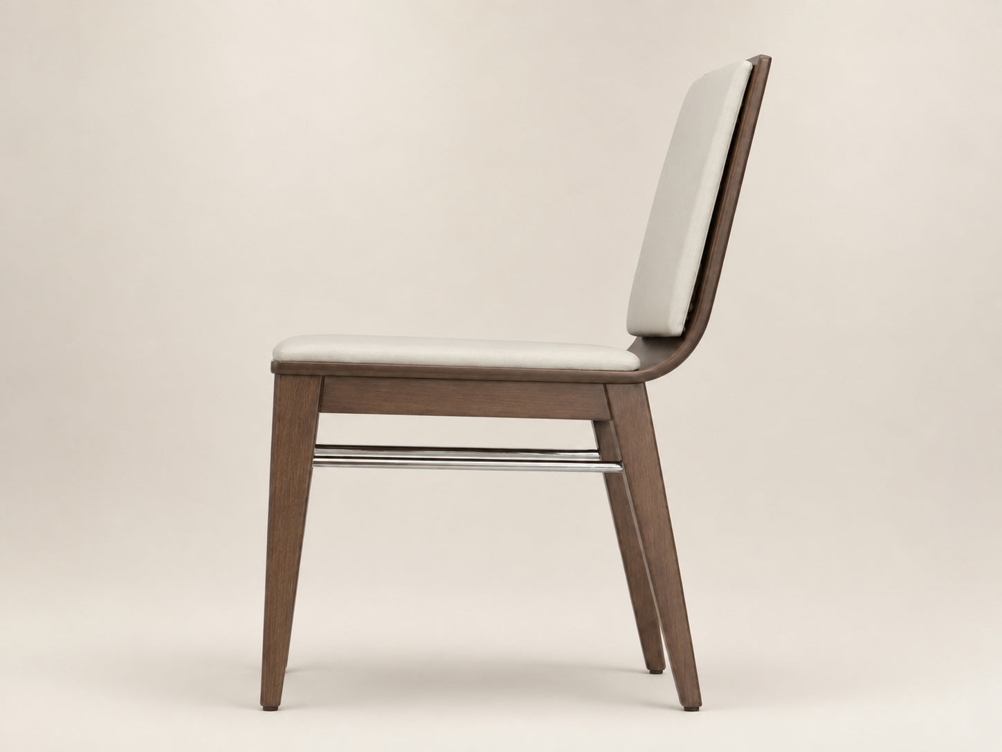 Arc upholstered dining chair with a refined American walnut frame, supportive backrest and modern comfort