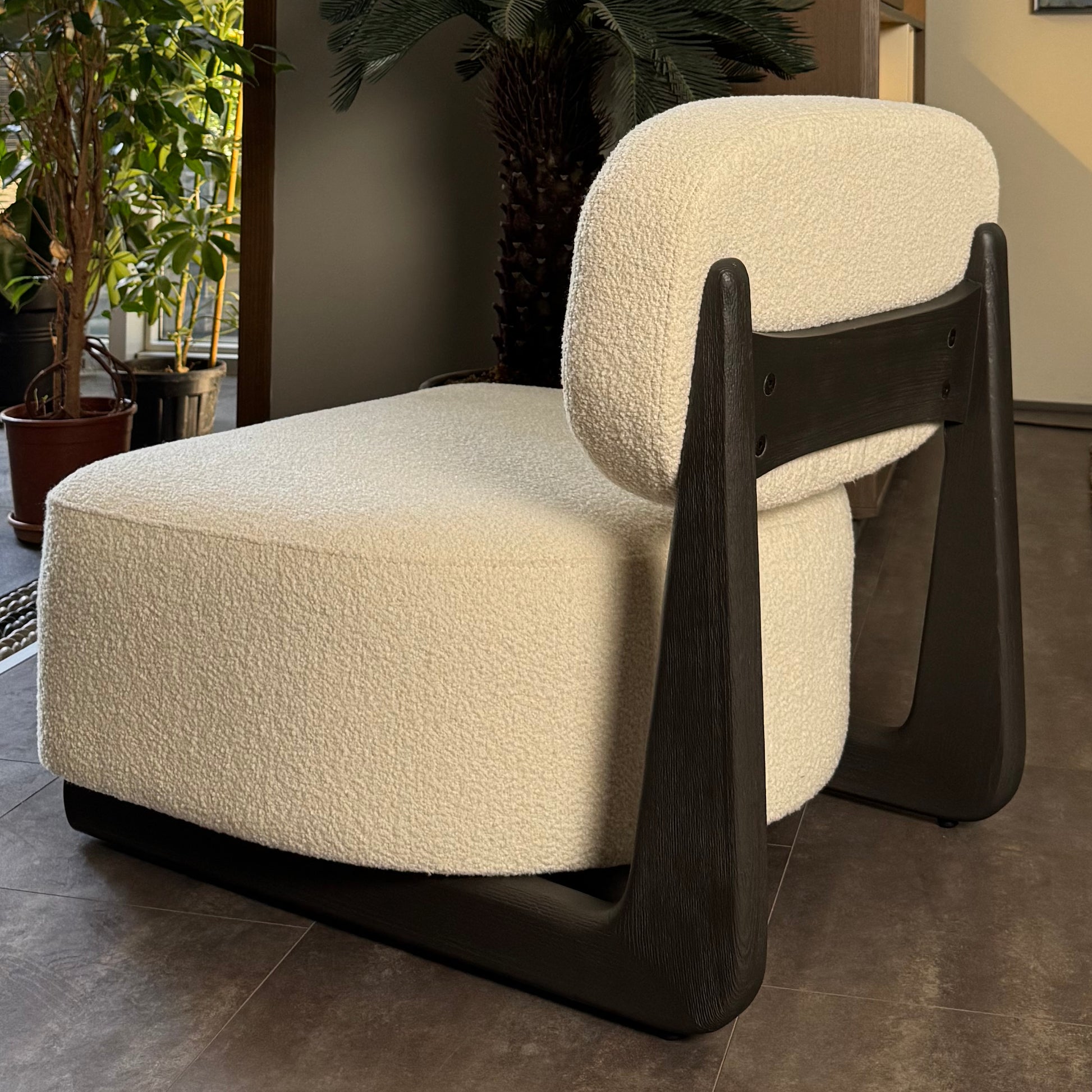 Aura armchair in a cozy living room with bouclé fabric