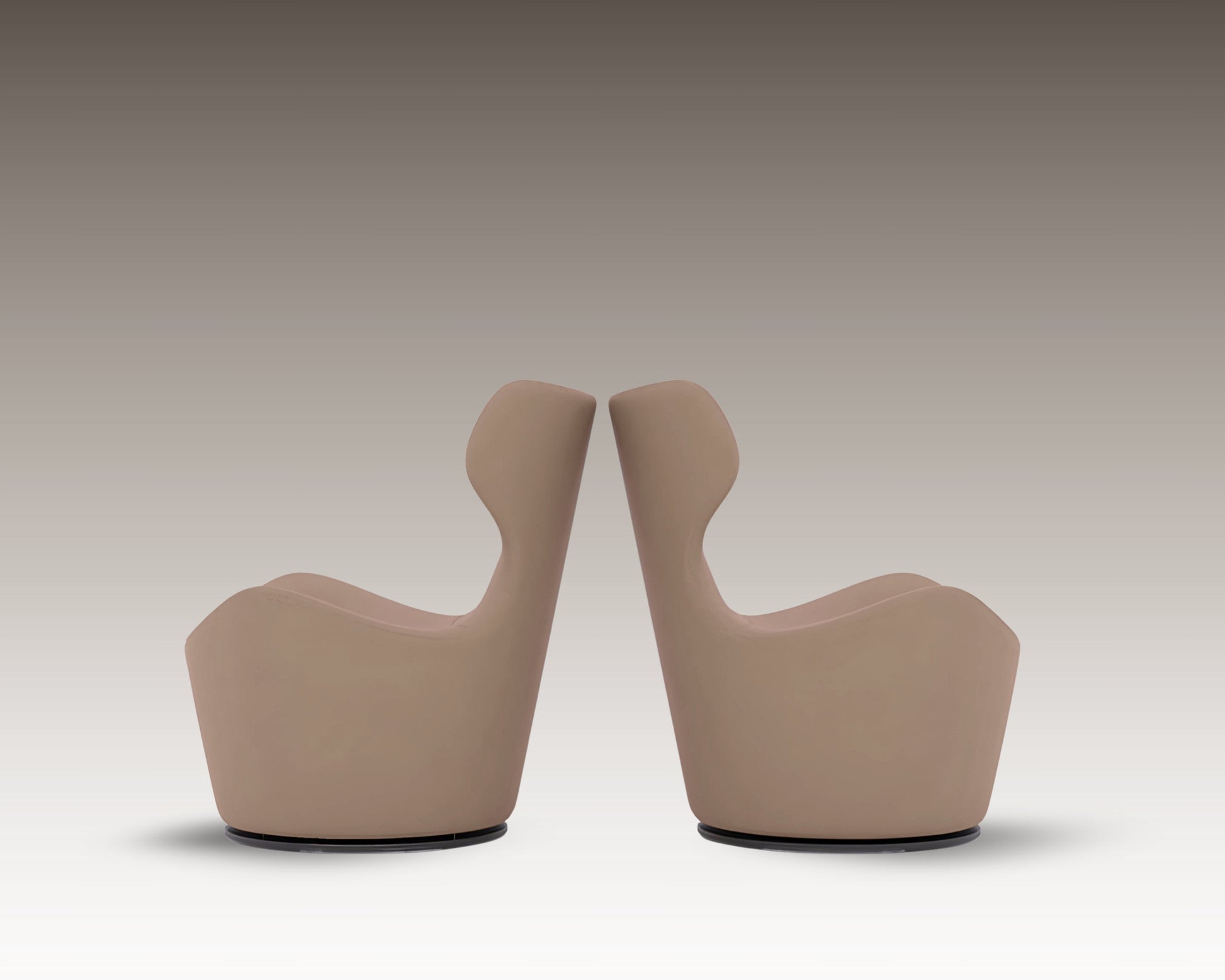 Side-by-side view of two Capri Armchairs in taupe leather with sculptural high backs, shown in mirrored positioning.
