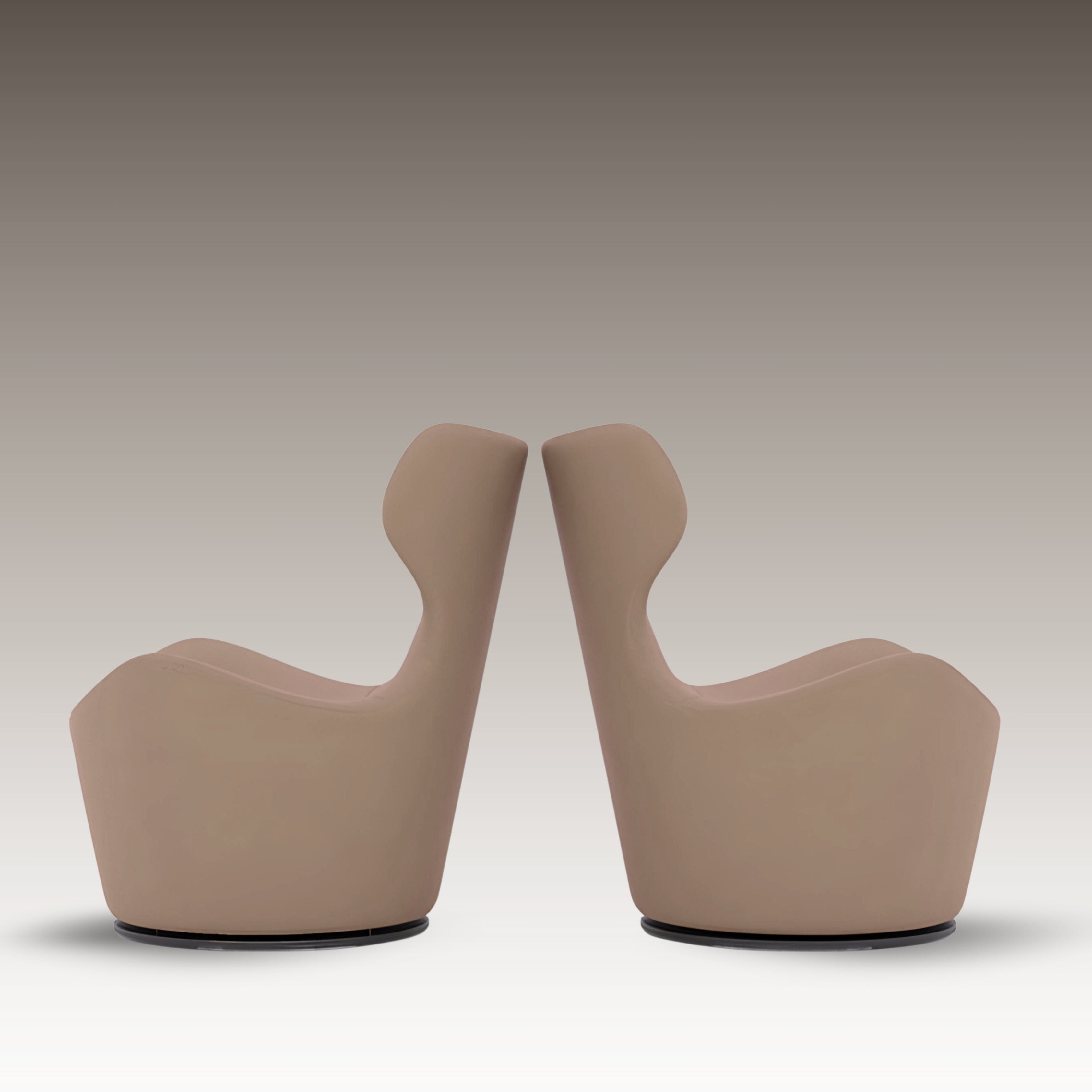 Side-by-side view of two Capri Armchairs in taupe leather with sculptural high backs, shown in mirrored positioning.