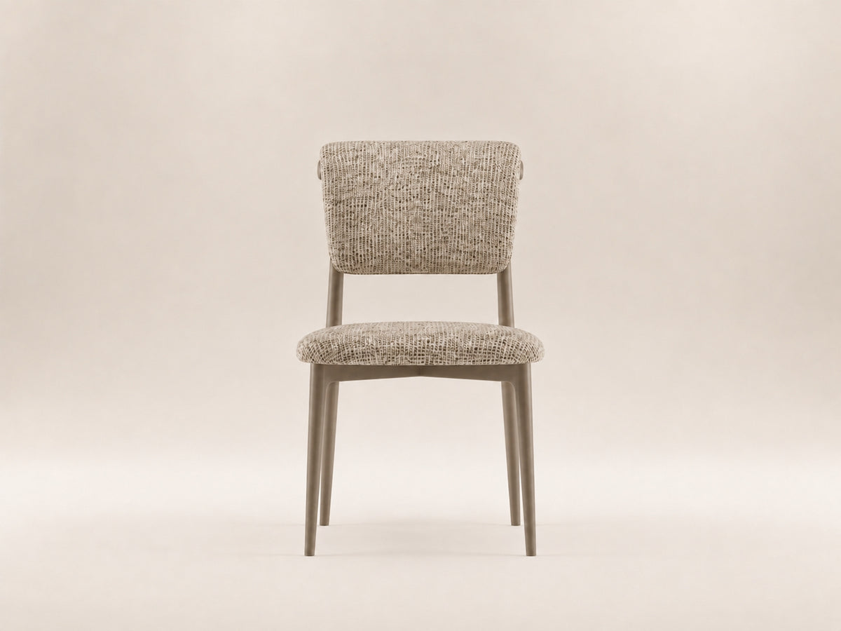 Enya Dining Chair by Canapy Furniture featuring a streamlined silhouette, angled backrest and cushioned modern comfort