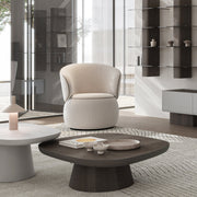 Moss Swivel Armchair in cream upholstery with black piping and rounded base 
