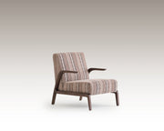 Side angle of Savanna Armchair showing curved wooden arms and vintage textile design