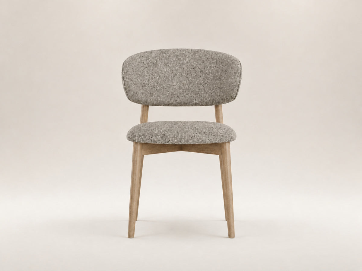 Tierre Oak Dining Chair by Canapy Furniture featuring a curved upholstered backrest and solid oak frame
