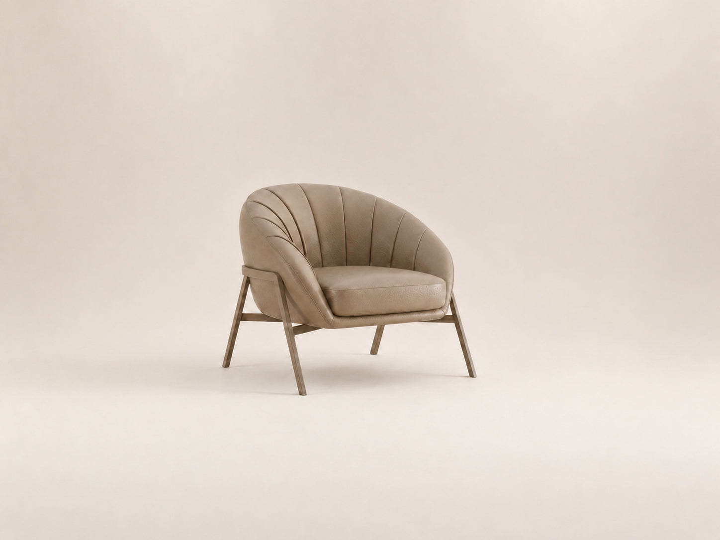 Vento accent chair with a curved backrest, plush cushioning, architectural base and refined vertical channel stitching